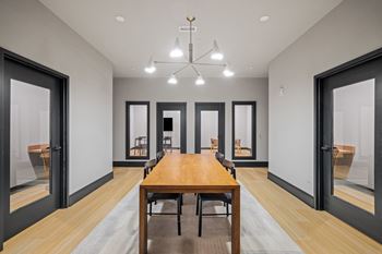a dining room with a wooden table and chairs and a chandelier